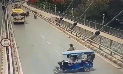 a group of people riding a e rickshaw on a road