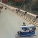 a group of people riding a e rickshaw on a road