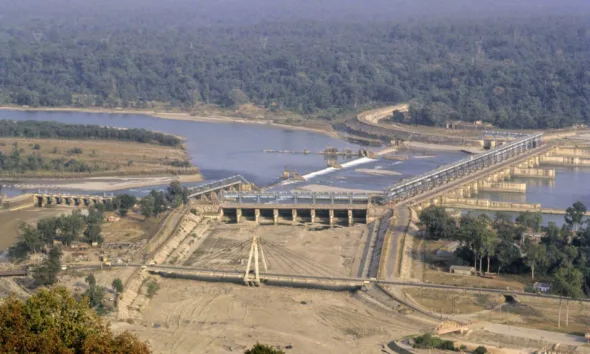 Aerial view of the Farakka Barrage on the Ganga River, showing the dam structure, river flow, and surrounding landscape.